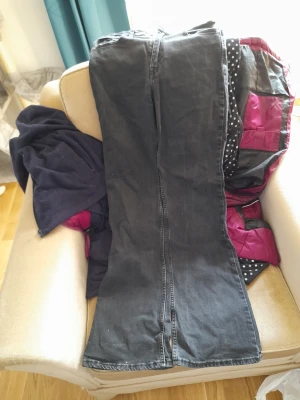 Svarta bootcut jeans - Säljer ett par svarta bootcut jeans med klassisk femficksdesign. Jeansen har en lätt utsvängd passform nedtill och synliga sömmar. Perfekta för dig som gillar en avslappnad men ändå trendig look.