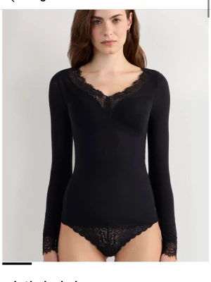 Svart Intimissimi topp - Svart långärmad topp från Intimissimi med v-ringning och spetsdetaljer vid halsringning och ärmslut. Sitter tight och är tillverkad i ett mjukt, tunt material som känns lyxigt mot huden. Använd max 3 gånger, storlek S köptes för 550kr, skicka prisförslag 