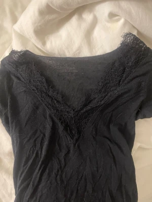 Intimissimi spets tröja i svart - Snygg svart topp med v-ringning och spets detalj 