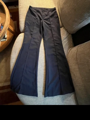 Marinblå kostymbyxor H&M - Snygga mörkblå kostymbyxor i storlek S från H&M. Byxorna är lågmidjade och har en utsvängd modell med fina pressveck framtill.  Använda ett fåtal gånger och i mycket bra skick🫶 