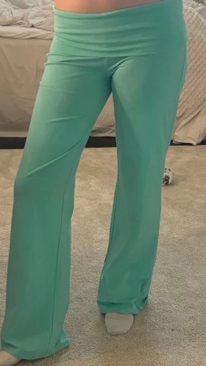 Teal yogapants (turkosa) - Säljer ett par turkosa mjukisbyxor (yogapants) med bred resår i midjan och utsvängda ben. De är gjorda i ett mjukt och stretchigt material som är riktigt skönt att ha på sig. Perfekta för chill eller när du vill ha något bekvämt. Märke ej angivet. Andvända en gång hör av vid frågor❤️❤️STRL 170