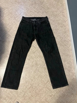 Svarta jeans från Weekday - Säljer ett par svarta jeans från Weekday i modellen Space Relaxed Straight. Klassisk femficksdesign och normalhög midja. Jeansen är tillverkade i bomull och har en stilren look som passar till det mesta.