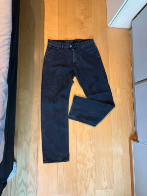 Svarta raka jeans - Säljer ett par svarta jeans med rak och avslappnad passform från weekday i modellen space. Snygg svart tvätt.