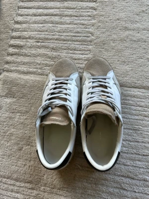 Vita och beige sneakers med mockadetaljer - Crimelondon skor i storlek 41. Cirka 8/10 skick.  Är en perfekt sko till sommaren. Tveka inte att höra av er vid minsta fundering.