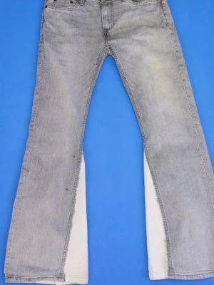 Grå flared jeans från Dressmann - Snygga grå bootcut jeans från Dressmann med klassisk femficksmodell och bälteshällor. Jeansen har en ljus tvättad look och är tillverkade i bomull. Perfekta för dig som gillar en avslappnad men trendig stil.