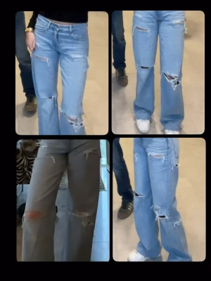 Blå slitna baggy jeans med hål - Baggy jeans i ljusblå denim med flera slitningar och hål på benen. Modellen har hög midja och vida ben för en avslappnad streetstil. Perfekta för dig som gillar en trendig och edgy look.