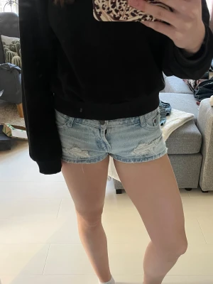Ljusblå denimshorts med slitningar - Säljer ett par ljusblå denimshorts med slitna detaljer. Köpta second hand så vet inte vilket märke det är, men det står Wear på knapparna så antar att den är därifrån 💋😽😁