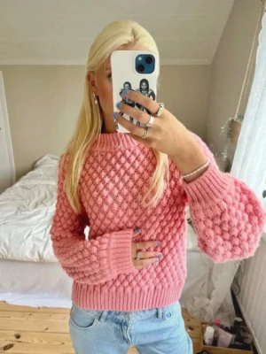Korall stickad tröja  - Superfin rosa/korallfärgad stickad tröja med bubbligt mönster och ribbade muddar. Tröjan har rund halsringning och är gjord i ett mjukt material som känns skönt mot huden. Perfekt för dig som gillar färg och vill ha något mysigt och trendigt i garderoben. Är väldigt populär och efterfrågad 💕