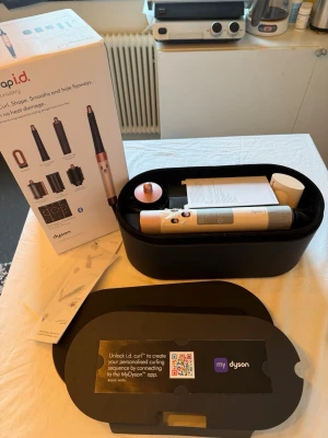 Dyson Airwrap i.d. hårstyler - Säljer en Dyson Airwrap i.d. hårstyler i silver och koppar med flera stylingtillbehör. Kommer i en snygg svart förvaringsbox med kopparfärgad kant. Perfekt för att skapa lockar, volym och släta frisyrer utan värmeskador.
