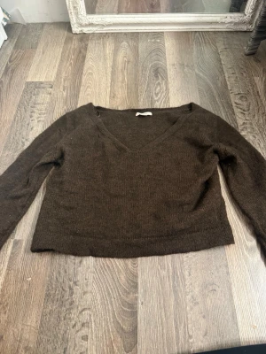 Brun stickad tröja Gina Tricot - Mysig brun stickad tröja från Gina Tricot med v-ringning och långa ärmar. 