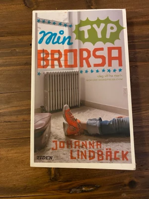 Min typ brorsa av Johanna Lindbäck - Ungdomsroman med färgstarkt omslag där en person i orange sneakers ligger på golvet. Boken handlar om tonårsliv, familj och relationer i Luleå. Pocketutgåva med mjukt omslag och tydlig, modern design. Perfekt för dig som gillar samtida svensk ungdomslitteratur.