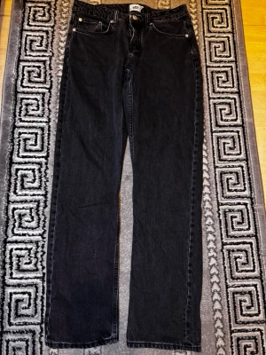 Svarta raka jeans från 157 - Säljer ett par svarta jeans från 157 med rak passform och klassisk femficksdesign. Jeansen har silverfärgade knappar. Materialet är denim i bomull.💕
