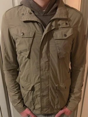 Woolrich Fieldjacka - Tja! Säljer en beige fieldjacka med dragkedja och knappar framtill. Jackan har två stora fickor med lock på framsidan och justerbar midja baktill. Materialet är tunt och smidigt, perfekt för blåsiga dagar. Bara att skriva vid minsta fundering!!✌️⚡️