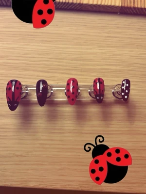 Press-on naglar med nyckelpigemotiv - Snygga press-on naglar i mandelform med handmålat nyckelpigemotiv i rött och svart med svarta prickar. Naglarna är gjorda av plast och har en glansig finish. Perfekt för dig som vill ha en lekfull och unik nageldesign. ❗️EGEN DESIGN❗️