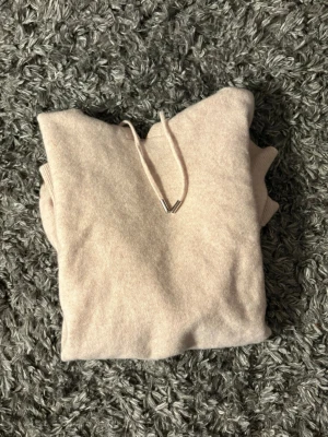 Beige merinoull hoodie - Ljusbeige hoodie med huvaa tillverkad i 100% merinoull. Hoodien är från garde grisch. Perfekt nu till våren och sommarens kvällar. Skriv vid minsta fundering🙌
