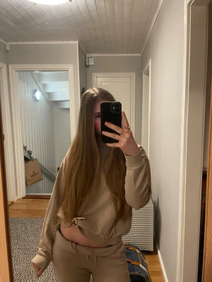 Beige mjukisset - Säljer ett mjukisset i beige färg från Kappahl. Storleken på tröjan är 158-164 och byxorna 152