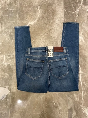 Tiger of sweden - Helt nya jeans ifrån tiger of Sweden med prislappen kvar på. Storleken är W30 L30. Modellen är evolve. Passformen är någon stans mellan slim och straight. Snygg tvätt