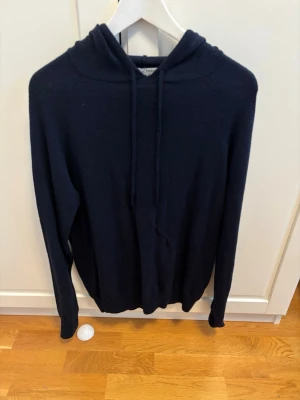 Merinoull hoodie ifrån Tiger of Sweden  - En riktig schysst hoodie ifrån tiger of Sweden i 100% merinoull. Lagning har gjorts där fram pågrund av två extremt små hål, inget som syns alls vid användning.Priset går såklart att diskutera så det är bara att buda