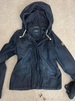 Mörkblå jeansjacka med huva från ONLY - Assnygg jeans jacka med luva som är perfekt nu till våren💕 Inga defekter, knappt använd! Säljer billigt för att snabbt få mer plats i garderoben 
