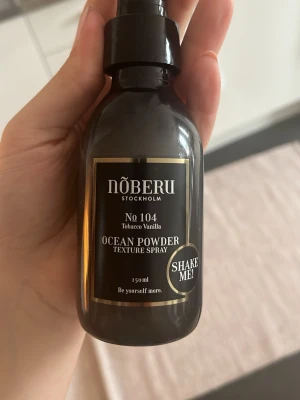 Nõberu Ocean Powder Texture Spray- saltvatten spray - Använd 1 gång.Ocean Powder Texture Spray från Nõberu Stockholm, doft Tobacco Vanilla. Kommer i en mörkbrun plastflaska med spraymunstycke och guldiga detaljer. Innehåller 150 ml och ger textur till håret. Perfekt för att skapa volym och stadga. 
