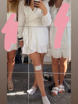 Vit studentklänning  - Säljer en kort vit omlottklänning med långa ärmar och volangkant nedtill. Klänningen har knyt i midjan och en v-ringad halsringning passar student eller avslutning men så fin som det är för en sommar kväll 