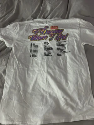 Vit Hov1 tour t-shirt Vi Dansar Vidare - Skriv privat vid intresse, Köpt på turné 2025, Vit t-shirt från Hov1 med tryck 'Vi Dansar Vidare I Livet' och turnédatum på ryggen. Framtill finns en liten krona tryckt på bröstet. Klassisk passform och rund halsringning. Bara provad 1 gång.