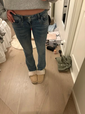 Blå bootcut jeans med låg midja - Säljer ett par blå bootcut jeans med låg midja från LTB. Jeansen har en snygg tvätt och sitter tajt över låren för att sedan bli lite vidare nedtill. Perfekta till en avslappnad och trendig look. 