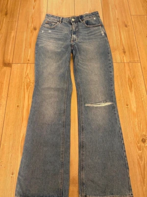 Blåa jeans - Ett par blåa jeans med hål i från Strandivarius😍😍Jättefint skick! Modellen är mid-high waist och säljer då dem är liiiite för stora i midjan på mig annars skitsnygga!!💗