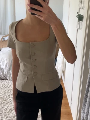 Beige figursydd blus med knappar  - Snygg beige blus med kort blus från Zara. Perfekt för en stilren look🙌🏼