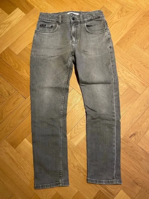 Calvin Klein Jeans - Säljer dessa gråa Calvin Klein jeans i bra skick. Storlek 14 vilket anses som 160cm. Vid frågor eller funderingar så tveka inte att höra av dig!😊