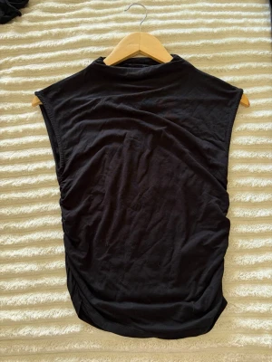 Svart ärmlös topp från Gina Tricot - Svart ärmlös topp från Gina Tricots Soft Touch .