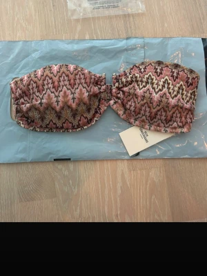 Becksödergaard bandeau-bikinitopp - Säljer en slutsåld snygg bandeau-bikinitopp från becksödergaard. Aldrig använd och lappen är fortfarande kvar.