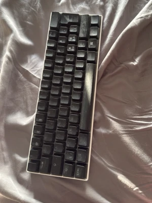 Kompakt svart tangentbord - Säljer ett kompakt svart tangentbord med vita kanter. Det är helt funger bart bara lite damit för jag inte använd på länge, det lyser på vilket sett man vill 