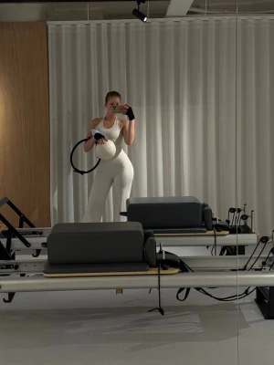 Vit sportbody med djup urringning - Säljer en stilren vit sportbody med djup urringning och breda axelband. Perfekt för pilates eller yoga. Materialet är stretchigt och följsamt för maximal rörelsefrihet. Snygg och enkel design utan synliga loggor.