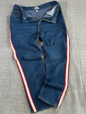 Custom L.L. Bean High Waist Side Stripe Hit Denim Women’s 12  - Custom L.L.Bean high waist jeans with bold red/cream side stripe – instantly elevates a classic pair. Super flattering high rise with relaxed tapered fit that gives that effortless Y2K / streetwear look. Perfect with sneakers or boots, easy statement piece.  Waist 39.5 cm women’s 12 (31”) Thigh 33 cm Rise 30 cm Length 100 cm  Worn and customized, good condition.