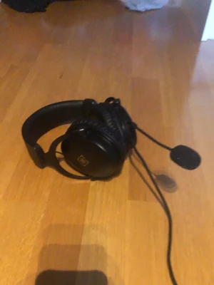 Svarta gaminghörlurar med Mick  - Säljer mina  gaming-hörlurar, tror det är deltaco. Bekväma med mjuka öronkuddar och ett huvudband som går att anpassa, perfekta för långa stunder vid datorn. Mikrofonen går att ta av om man  vill använda hörlurarna utan den. Hörlurarna funkar utan problem. Jag vet tyvär inte exat modell. Pris kan diskuteras 