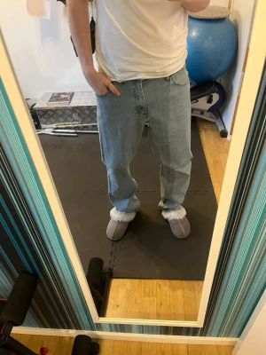 Ljusblå raka jeans från Wrangler - Säljer ett par ljusblå jeans från Wrangler med rak passform och klassisk femficksdesign. Jeansen har normal midja och är tillverkade i denim. Perfekta för en avslappnad stil