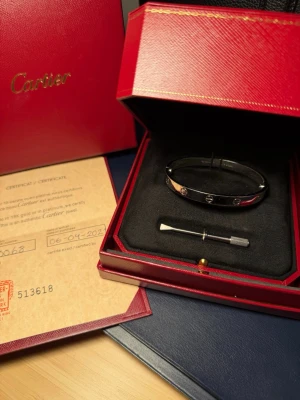 C armband love 20 cm - C armband i modell LOVE i strl 20 cm. Doppat i vitt 18k guld (dvs. tjockt lager) och med skruvar på båda sidor som sticker ut lite i enlighet med modellen LOVE! Tål vatten och ånga (bastu)! Gjord på beställning åt mig, men kommer dessvärre inte längre till användning då den är lite tajt… Kommer med låda och certifikat! 