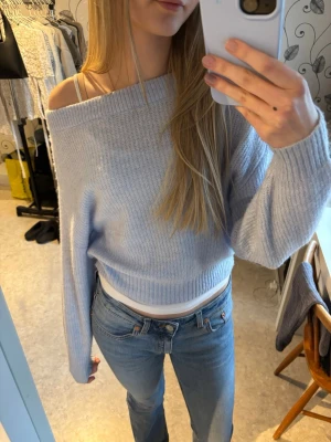 Ljusblå off shoulder stickad tröja - Jättesöt ljusblå stickad tröja med off shoulder-passform i storlek xs . Tröjan har långa ärmar och bred ribbad kant vid halsringningen🫶🏻