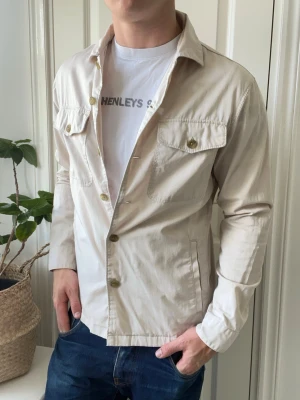 East west overshirt  - East west overshirt, en liten fläck som ni ser, och nej det är inte en stor mörk fläck det är bara ljuset utan en liten röd fläck. Inga defekter annars.  Modellen i bilderna är 180 cm 75 kg och bär Storlek  M, Kom med frågor! 🌟 (Kan gå ned i pris vid köp av paket 😉) 