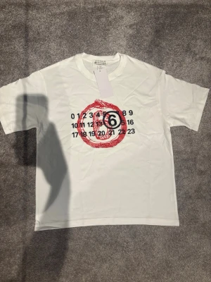 Vit Maison Margiela t-shirt med tryck - Riktigt fet vit tshirt från maison margiela med ett fett tryck på framsidan.