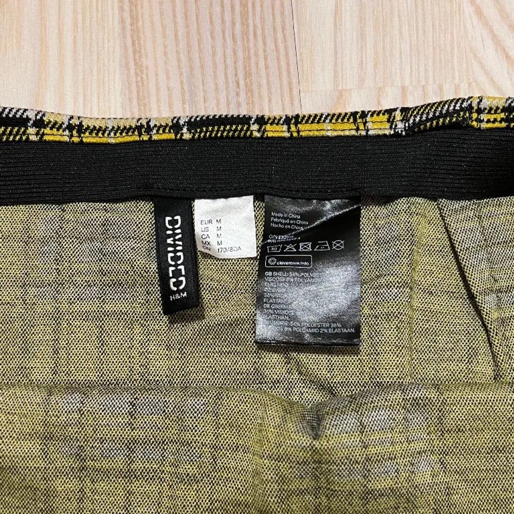 Kort kjol i gulsvart-rutigt mönster från HM Divided i storlek M. Använd enstaka gång. 54 % polyester, 36 % viskos, 8 % polyamid, 2 % elastan. . Kjolar.