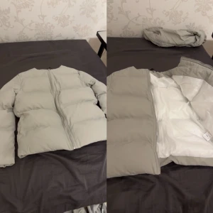 Grå jacka - En grå jacka med vitt inuti. Aldrig använt. Väldigt tjock och varm. En matchande halsduk tillgår.