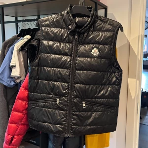 Moncler Gui Väst - Moncler Gui väst i bra skick, 2 små pinholes framtill som inte syns. Svart storlek 2 passar S/M. Nypris 9000 mitt pris 3000 men tar emot rimliga bud! Över 70 refs finns från nöjda kunder, bara att skriva vid frågor eller funderingar!