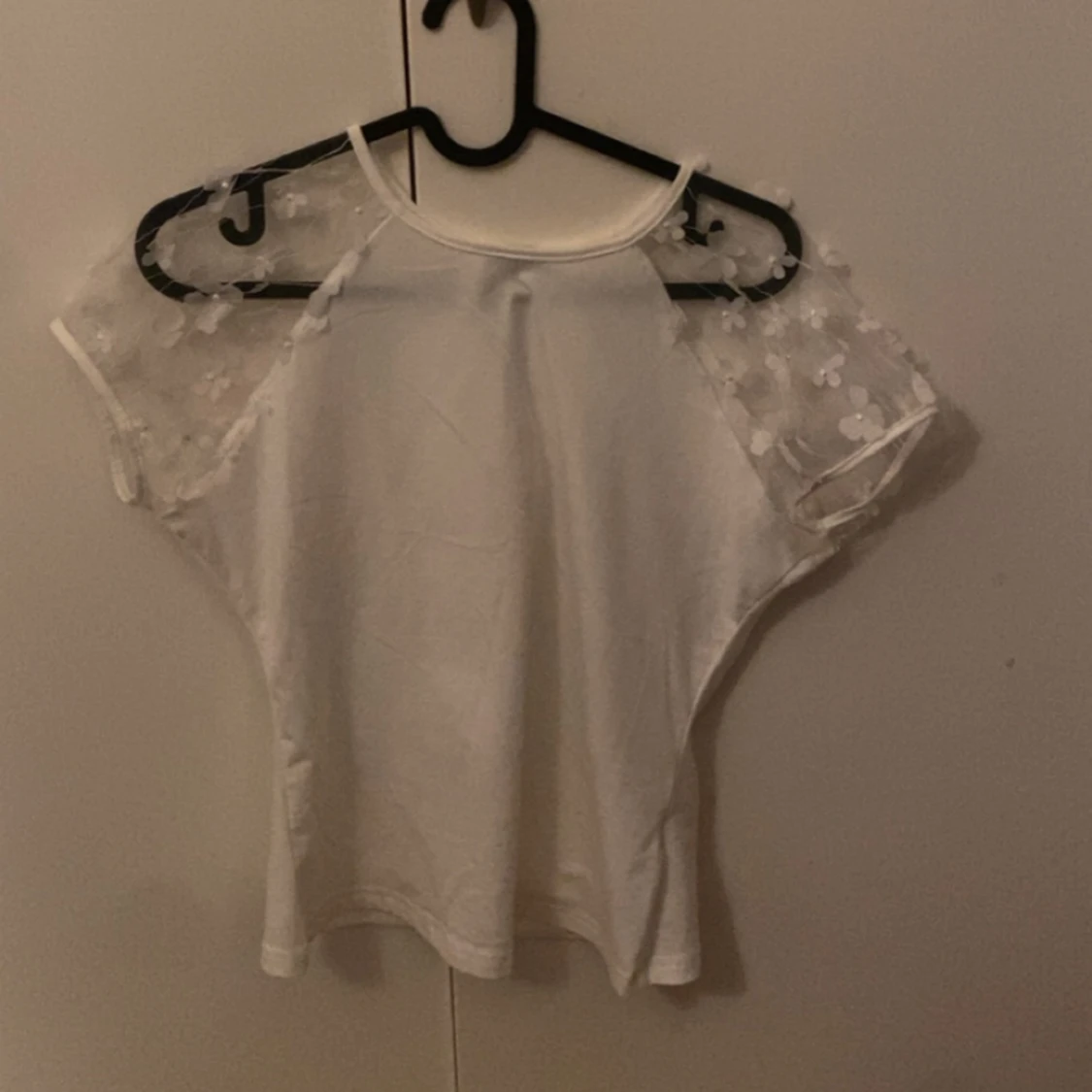 Vit tröja med blommiga armar 