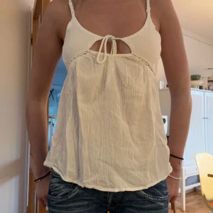 Jättefin sommartopp köpt i Spanien - Fint vitt sommarlinne med knytning. Jättefin nu till sommaren och väldigt skönt och luftigt material.