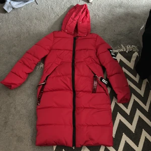 Vinterjacka - Tjock lång jacka märkt i strl L, men skulle snarare säga att det är en medium då den var tajt på mig med en tjocktröja på. Fuskpäls till luvan följer med, oanvänd