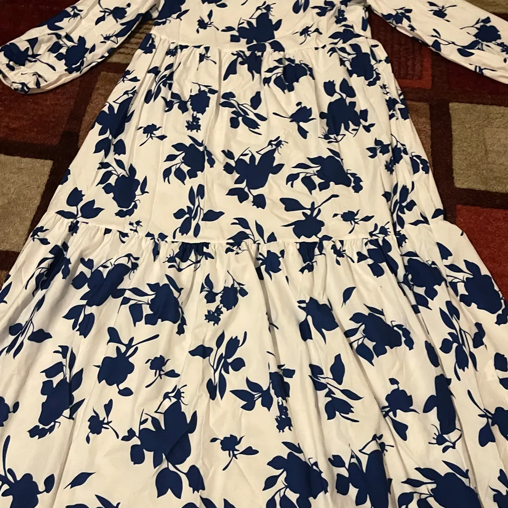En jättefin blommig sommarklänning i vit och blå, som är perfekt nu till vår och sommaren. Den är s men skulle säga att passar även M🤗🥰. Mekot.