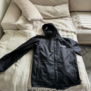 The north face windbreaker  - It is waterproof and very nice.