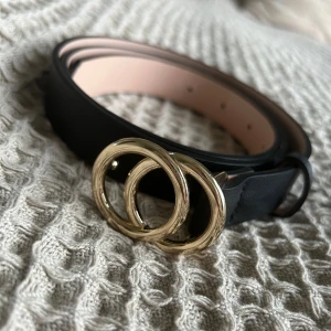 Svart skärp - Svart skärp från H&M. 98 cm. Har inte noterat några defekter.